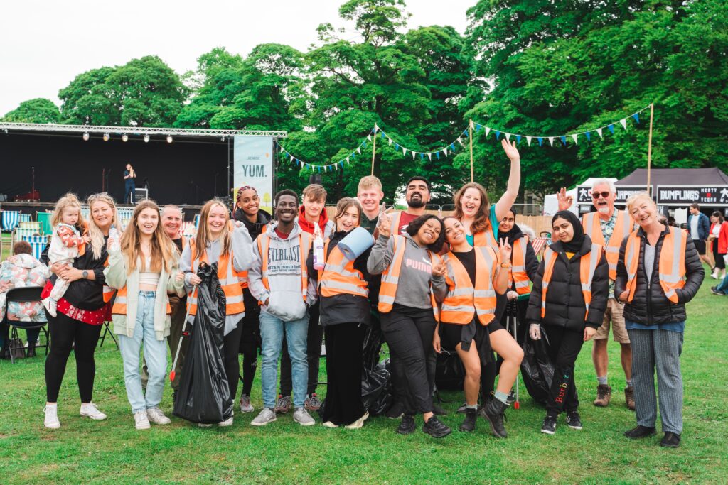 The Steward Team at North Leeds Food Festival 2022 stood in front of the stage having their team photograph taken.